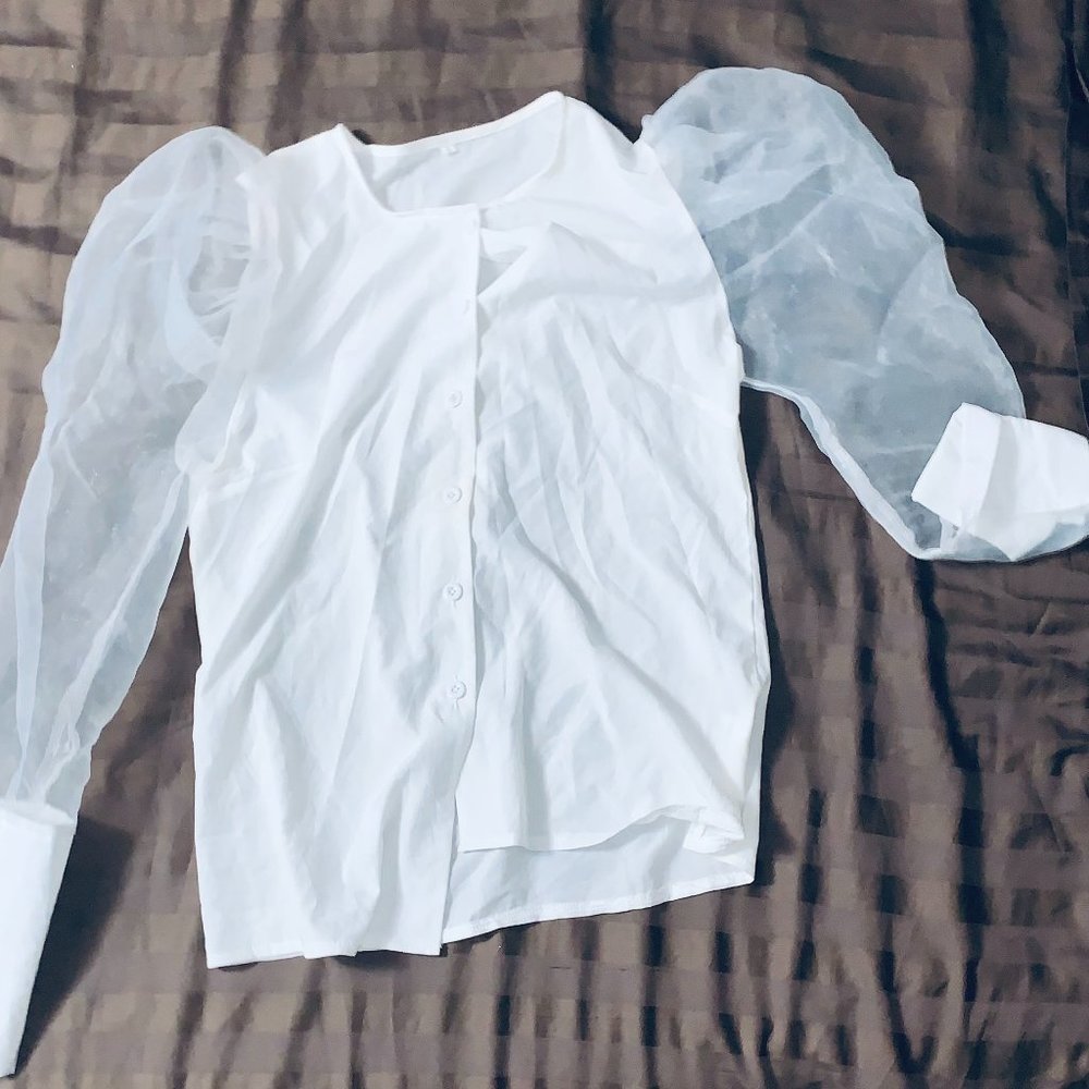 a blouse with sleeves that are see through